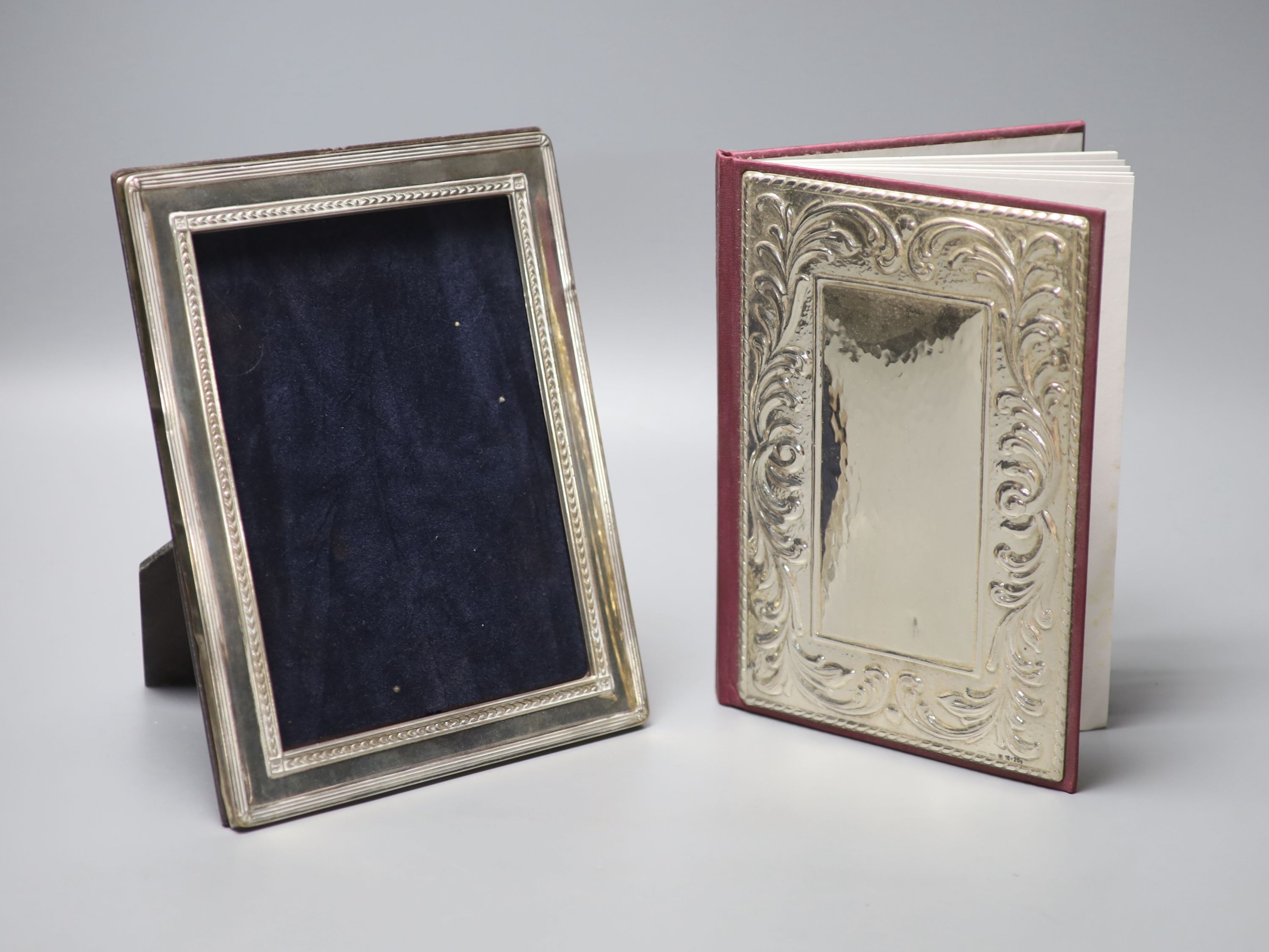 A modern silver mounted photograph frame, 22cm, and a silver mounted address book.